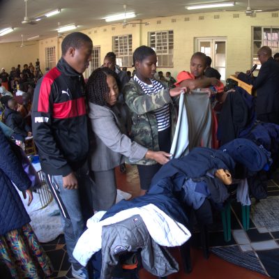 Local residents sort through hundreds of coats brought by Simon's Branch